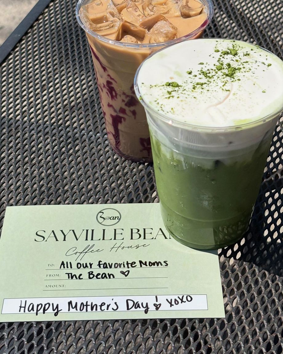Two iced drinks beside a Sayville Bean gift card